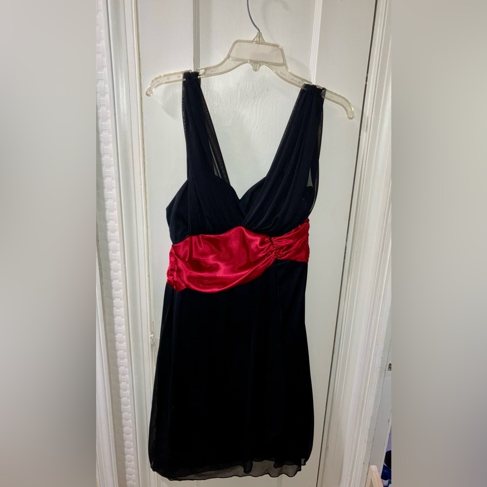 Asymmetrical sash mid length formal black dress.